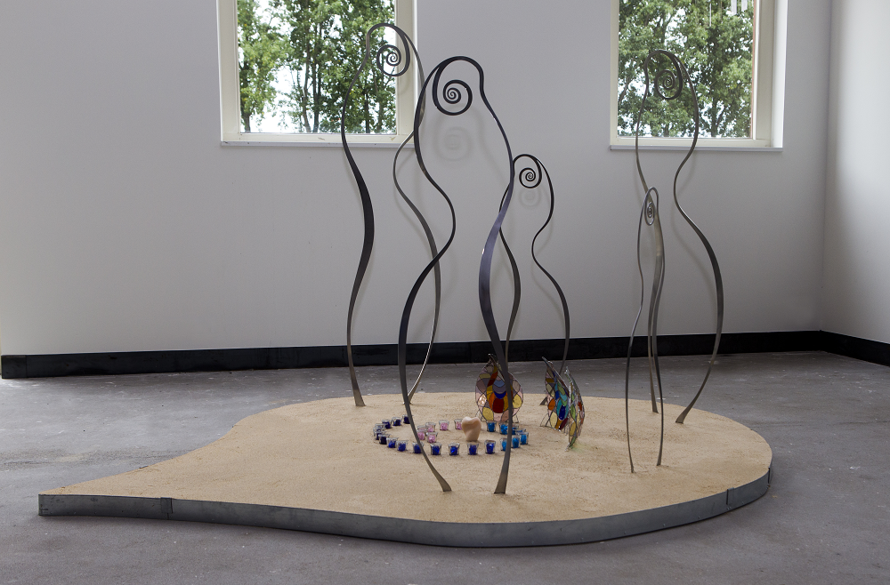 Stainless steel figures around marble statuette